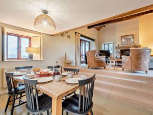 a dining room and living room with a table and chairs at 3 Bed in Penrith oc-93379 in Orton
