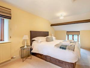 a bedroom with a large white bed in a room at 3 Bed in Penrith oc-93379 in Orton