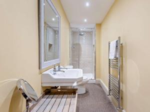 a bathroom with a white sink and a shower at 3 Bed in Penrith oc-93379 in Orton