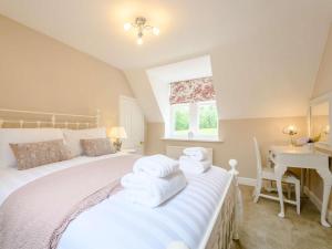a bedroom with a bed with white towels on it at 1 Bed in Langholm oc-83343 in Langholm