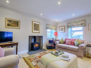 a living room with a couch and a fireplace at 1 Bed in Lockerbie oc-86068 in Lockerbie