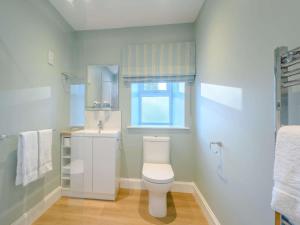 a bathroom with a toilet and a sink and a window at 1 Bed in Lockerbie oc-86068 in Lockerbie +8 photos