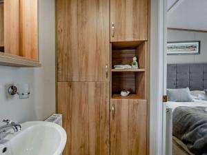 a bathroom with a sink and a bedroom with a bed at 2 Bed in St. Andrews oc-95035 in St. Andrews +18 photos