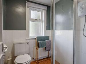 a bathroom with a toilet and a window and a shower at 3 Bed in Biggar oc-82924 in Biggar +18 photos