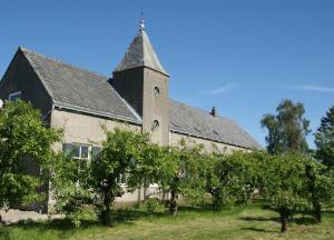 an old building with trees in front of it at Bed & Brood De Vogelpoel in Wijk bij Duurstede