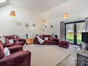 a living room with two couches and a tv at 3 Bed in Cupar oc-54394 in Peat Inn 