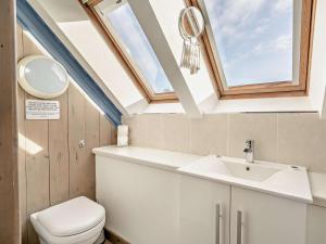 a bathroom with a toilet and a sink and a skylight at 3 Bed in Cupar oc-54394 in Peat Inn  +24 photos