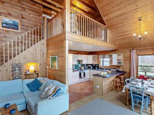 a living room and kitchen in a log cabin at 3 Bed in Fort William oc-95783 in Torlundy