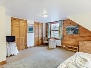 a bedroom with a bed and a tv in it at 3 Bed in Fort William oc-95783 in Torlundy