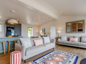 a living room with two couches and a kitchen at 2 Bed in Anstruther oc-83173 in Anstruther