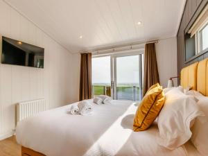 a large white bed with two dogs laying on it at 2 Bed in Anstruther oc-83173 in Anstruther