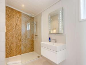 a white bathroom with a sink and a shower at 2 Bed in Anstruther oc-83173 in Anstruther +18 photos