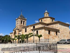 a church with two towers and a fence in front of it at KASANZAS in Fuentespina
