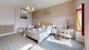 a bedroom with a bed and a table and chairs at Apt Giada Salò magic view in Salò +57 photos