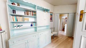 a room with a large book shelf with books at Apt Giada Salò magic view in Salò