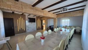 a large room with a long table and chairs at Casa Baraceanu Bran in Bran