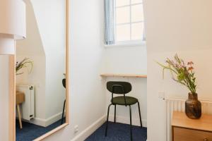 a mirror in a room with a chair and a desk at Nomad City Hotel - Odense in Odense +134 photos