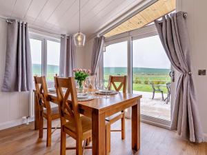 a dining room with a table and chairs and a large window at 2 Bed in St Andrews oc-94606 in St. Andrews