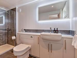 a bathroom with a sink and a toilet and a mirror at 2 Bed in St Andrews oc-94606 in St. Andrews