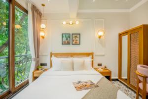 a bedroom with a bed and a large window at Staymaster Veridian Standard 2BHK Near Calangute Beach in Calangute +43 photos