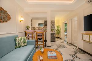 a living room with a couch and a table at Staymaster Veridian Standard 2BHK Near Calangute Beach in Calangute