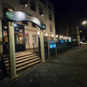 a building with a sign in front of it at night at Pension Villa Grün in Zwickau