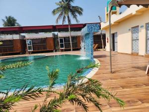 a swimming pool in a house with a wooden deck at Sheoak Retreat Tajpur in Tajpur +13 photos