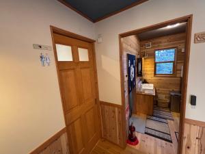 a door leading to a kitchen in a cabin at 離れの宿 かぶろの庭 離れの宿 KuRA in Matsukawa +43 photos