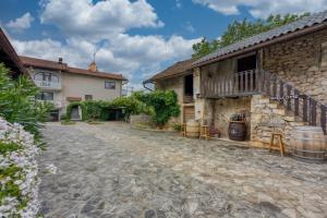 an external view of a house with a stone courtyard at Apartma pri Cesarjevih in Sežana