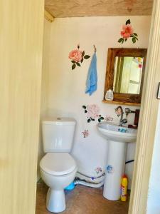 a bathroom with a toilet and a sink at The Secret Garden House in Ijevan