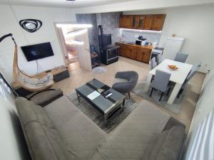 a living room with a couch and a table at Hidden Oasis PeSa - Luxury Villa with Pool & Spa in Podgorica