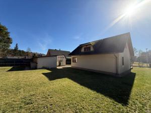 a small white building with the sun in the sky at Ferienhaus Villa Waldblick in Kolkwitz