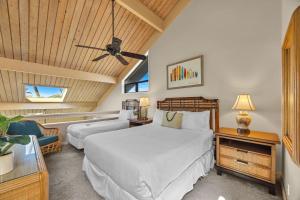 a bedroom with two beds and a ceiling fan at Kahana Village 9 · KHV 9 2BR Oceanfront Condo w Panoramic Maui in Lahaina
