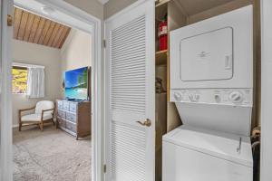 a laundry room with a washer and dryer at Kahana Village 9 · KHV 9 2BR Oceanfront Condo w Panoramic Maui in Lahaina +48 photos