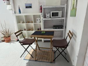 a table and two chairs in a room at La dolce vita in Mala