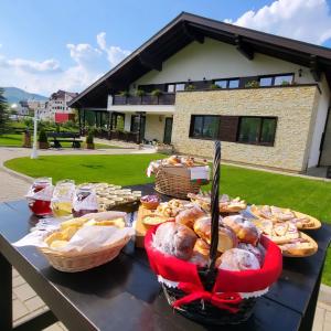 a table with many different types of food on it at Niro Residence in Gura Humorului