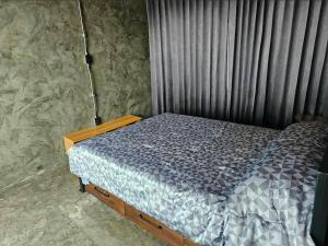 a bedroom with a bed in a room with curtains at Navy Medic 36 Poolvilla in Sattahip