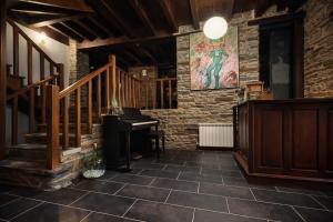 a room with a staircase and a grand piano at Casa do Fidalgo in A Pontenova +40 photos