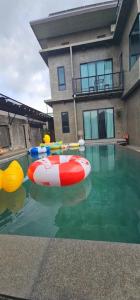 a swimming pool with an inflatable raft in the water at Navy Medic 36 Poolvilla in Sattahip +6 photos
