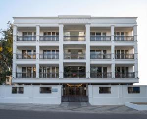 a white building with balconies on the side of it at Arunaragha in Mysore