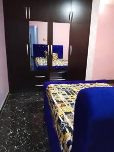 a room with two beds and two mirrors at Aduniniyi 7 Shines in Igando +2 photos