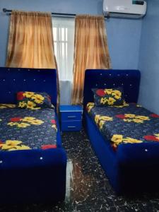a room with two beds in a room at Aduniniyi 7 Shines in Igando