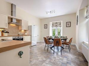 a kitchen and dining room with a table and chairs at 3 Bed in Langholm oc-95053 in Langholm