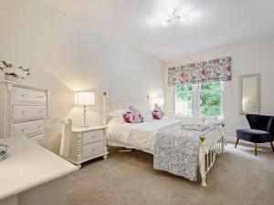 a white bedroom with a bed and a window at 3 Bed in Langholm oc-95053 in Langholm