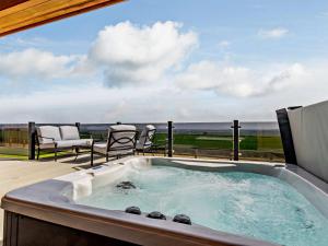 a jacuzzi tub with two chairs and a patio at 2 Bed in Anstruther oc-83174 in Anstruther