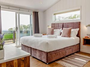 a bedroom with a large bed with a large window at 2 Bed in Anstruther oc-83174 in Anstruther +17 photos