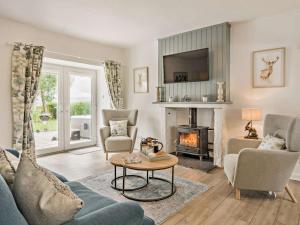 a living room with a couch and a fireplace at 3 Bed in Crieff oc-92683 in Madderty
