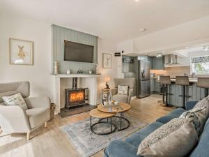 a living room with a couch and a fireplace at 3 Bed in Crieff oc-92683 in Madderty
