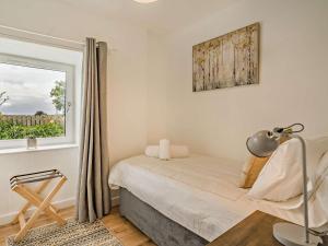 a bedroom with a bed and a window at 3 Bed in Crieff oc-92683 in Madderty