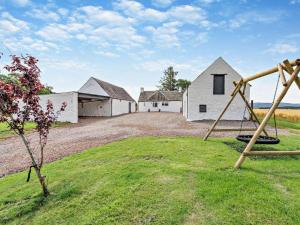 a group of houses with swings in a yard at 3 Bed in Crieff oc-92683 in Madderty